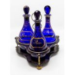A set of three Georgian Bristol blue glass decanters and stoppers, of mallet shape and with