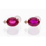 A pair of ruby, diamond and 18ct white gold studs, the oval cut rubies set in four claw mounts,