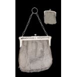 A white metal mesh evening purse, the openwork trellis pattern mount with typical clasp and chain,