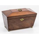 A George III mahogany tea caddy, of sarcophagus form with brass ring handle, the hinged top