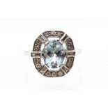 An aquamarine and diamond platinum ring, the oval cut claw set aquamarine measuring approx. 8.9mm