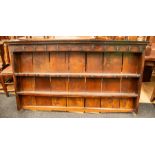 An 18th Century oak dresser, the rack with moulded cornice above a plain frieze fitted with game