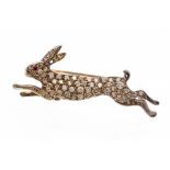 A diamond brooch, depicting a running hare, the body pave set with brilliant cut diamonds, ruby