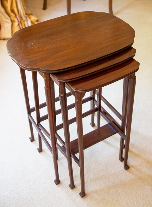 A reproduction nest of three mahogany tables,