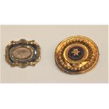 An early Victorian mourning brooch, gilt metal mount, the centre with a glass panel enclosing