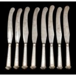 A set of eight George III silver hafted dinner knives, Sheffield 1787, with steel blades and shell
