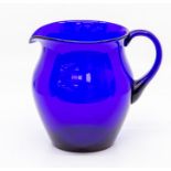 An early 19th Century Bristol blue glass jug, of ovoid form with plain loop handle, 16.5cm high.