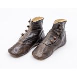 A pair of brown leather baby boy's boots with four button fastenings, 1860/70's, British design