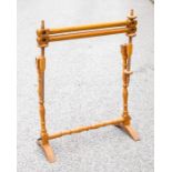 A 19th Century walnut embroidery frame, with turned supports, raised on plain arched supports,