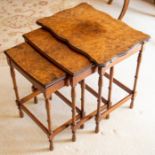 An Edwardian nest of three walnut tables,