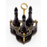 A Georgian Bristol blue glass three-bottle cruet, circa 1800-1810, the three bottles facet cut and