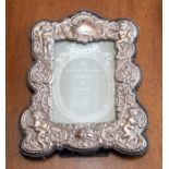 A silver mounted photo frame with embossed decoration.