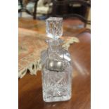 A cut glass decanter and stopper with silver 'Sherry' label.
