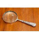 A silver-handled magnifying glass.