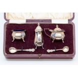 A cased silver three piece cruet, Alexander Clark, Birmingham 1924, of octagonal form and comprising