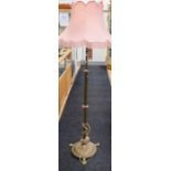A late Victorian/Edwardian brass telescopic standard lamp, with floret centre knop, the domed base