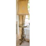 A late Victorian brass standard lamp, the reeded column with central circular onyx-mounted tier
