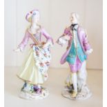 A pair of German porcelain figures of a maiden and gallant,