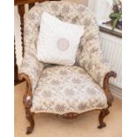 A Victorian mahogany-framed upholstered button-back armchair, with arched back and scroll-moulded