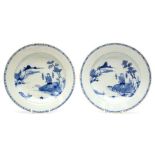 Two Chinese blue and white plates, 18th Century, of plain circular form and decorated with a