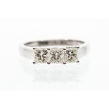 A three stone diamond and 18ct white gold  ring, comprising three claw set princess cut diamonds,