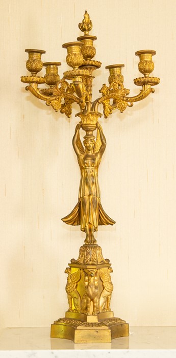 A pair of French Empire style gilt metal figural four-branch candelabra, circa 1890, modelled as