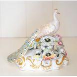 A Royal Crown Derby figure of a peacock,