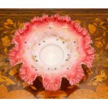 An opalescent glass dish, circa 1900, of frilled-edge form, the white glass fading to pink at the