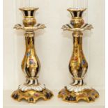 A pair of Coalport candlesticks, second half 19th Century, of lobed baluster form and decorated with