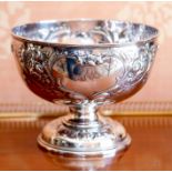 An Edwardian silver punch bowl, Sheffield 1905, of rounded form on a domed foot, embossed and chased