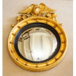 A Regency style giltwood, gesso and parcel ebonised convex wall mirror,