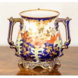 A Royal Crown Derby Imari tyg, dated 1901, of belied form with three scroll handles,decorated with