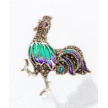 A plique a jour silver and enamel brooch in the form of a cockerel, with a pink sapphire set eye and