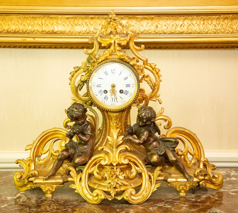 A French ormolu figural mantel clock, circa 1890, the barrel case with 4 inch enamelled dial