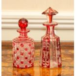 Two cranberry glass scent bottles and stoppers. (2)