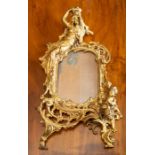 A gilt metal rococo-revival photo frame (at fault), 35cm high.