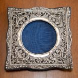 A silver mounted photo frame with embossed decoration.