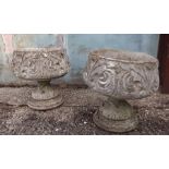 A pair of early 20th century weathered garden urns.