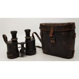 A pair of military binoculars in leather case.