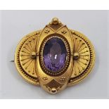 A Victorian precious yellow metal and amethyst brooch, of ovoid form with filigree and bead work