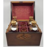 A 19th century mahogany decanter box, the silk lined fitted interior containing four associated