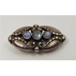 A Georg Jensen sterling silver and cabochon moonstone set brooch model no.156, stamped Georg