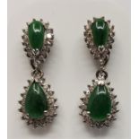 A pair of 9ct. white gold, apple green jade and clear stone set drop earrings, the hinged drop