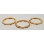 Three Chinese Qing dynasty ivory bangles. (3)