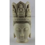 A 19th century Tibetan ivory head, carved with an elaborate crowned head dress with praying dieties,