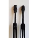 Tribal interest: A pair of African carved ebony figural staffs, carved as a man and woman, each