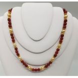 A precious yellow metal, cultured pearl and carnelian bead necklace, with silver gilt clasp, (yellow