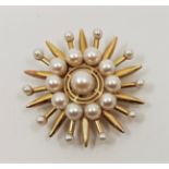 An 18ct. gold and cultured pearl star brooch, diameter 44mm. (gross weight 13.2g) Condition: Pin
