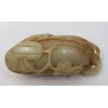 A Chinese celadon jade pebble carving, probably 19th century, carved as a melon and butterfly,