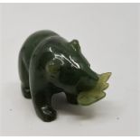 A carved spinach jade of a bear holding a fish, length 3.3cm.